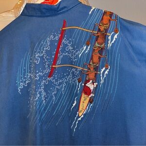 Tori Richard, Santa and his reindeer catching a wave in a canoe.